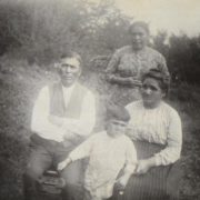 Aaron & Susan Pequongay seated, a daughter standing and a grandson in front