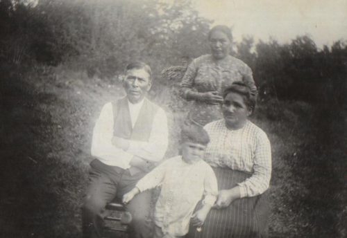 Aaron & Susan Pequongay seated, a daughter standing and a grandson in front